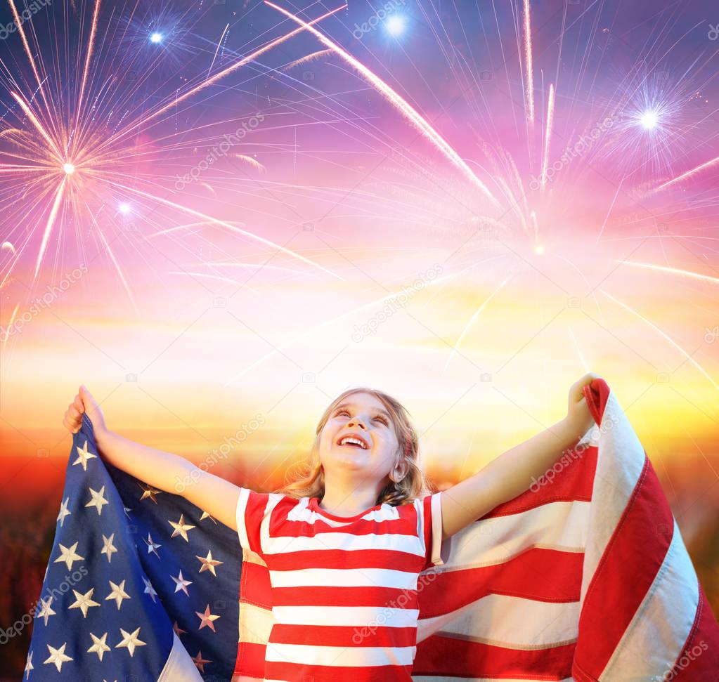 Little Girl With Usa Flag Celebrating Under Fireworks