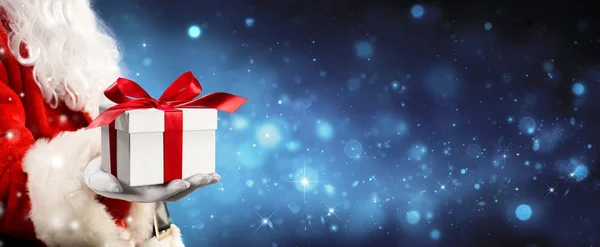Santa Claus Giving A Giftbox In Magic Night — Stock Photo, Image