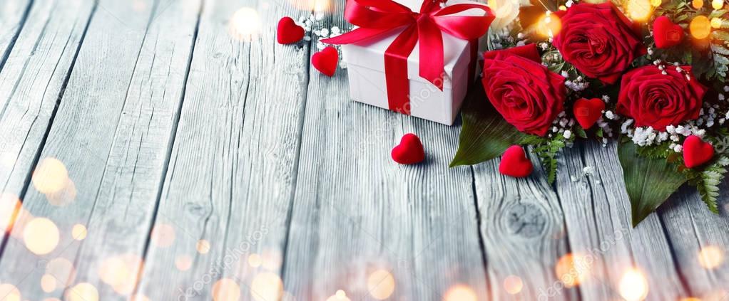 Valentines Card - Gift Box And Roses On Wooden Table With Lights