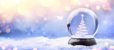  Shiny Christmas Tree In Snow Globe On Snow With Golden Lights clipart