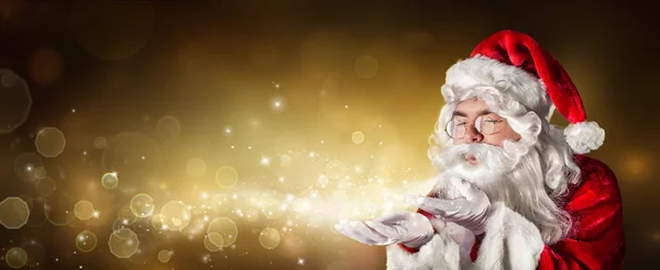 Santa Claus Blowing Magic Christmas Lights Złotym Tle — Zdjęcie stockowe
