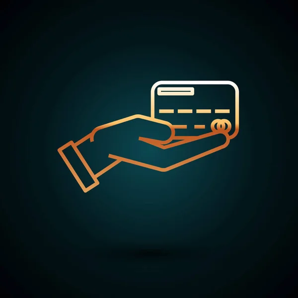 Guldlinje Mänsklig hand håller med kreditkort ikon isolerad på mörkblå bakgrund. Betalning online. Betala med kort. Finansiella transaktioner. Vektor Illustration — Stock vektor