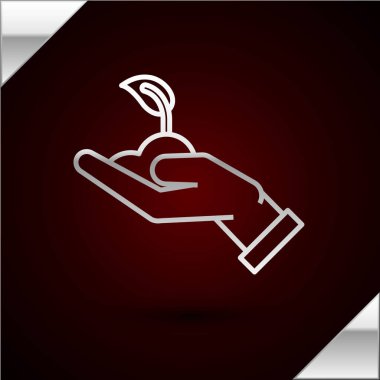 Çevre koruma ikonunun elindeki gümüş çizgi koyu kırmızı arka planda izole edilmiş. Tohum ve tohum. Fidan dikiyorum. Ekoloji konsepti. Vektör İllüstrasyonu