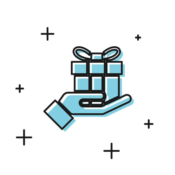 Schwarze Geschenkbox in der Hand Symbol isoliert auf weißem Hintergrund. Frohe Weihnachten und ein gutes neues Jahr. Vektorillustration — Stockvektor