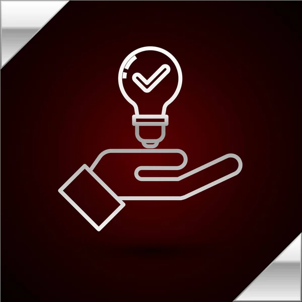 Silver line Light bulb in hand icon isolated on dark red background. Concept of idea. Vector Illustration — Stock Vector