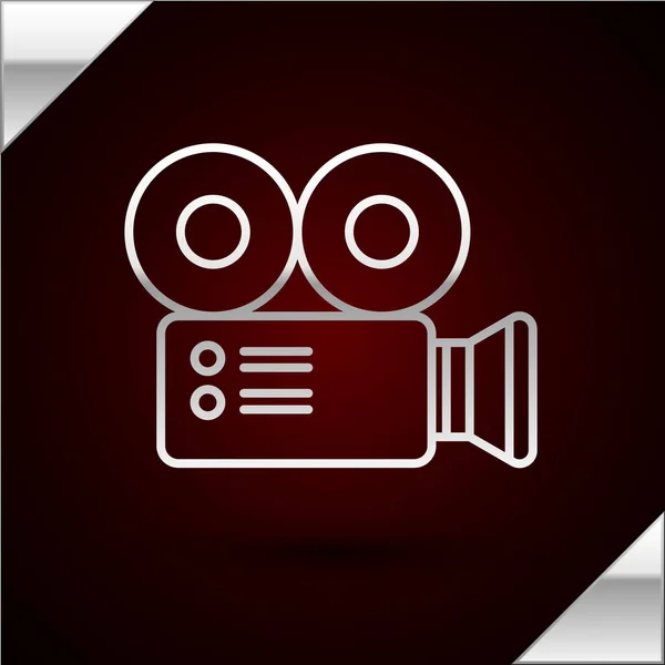 Línea plateada Icono de cámara de cine aislado sobre fondo rojo oscuro. Videocámara. Signo de película. Proyector de cine. Ilustración vectorial — Vector de stock