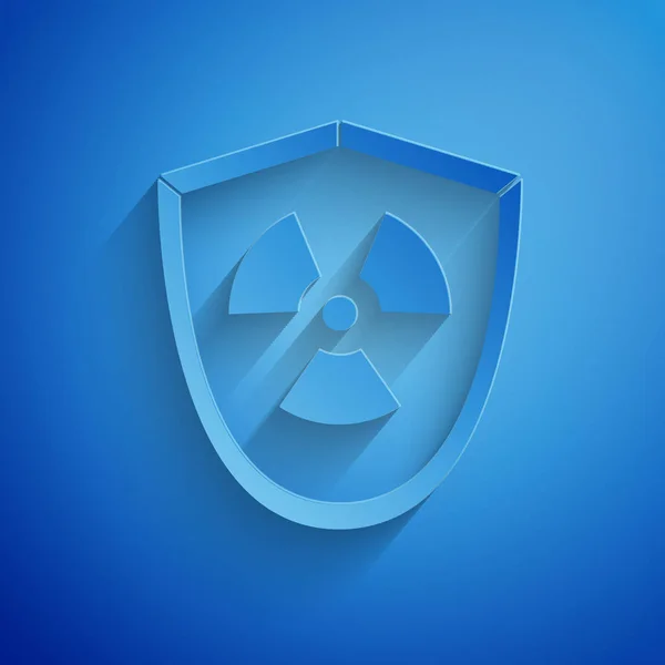 Paper cut Radioactive in shield icon isolated on blue background. Radioactive toxic symbol. Radiation Hazard sign. Paper art style. Vector Illustration — 스톡 벡터