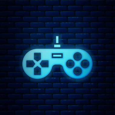 Parlayan neon oyun alanı simgesi tuğla duvar arka planında izole edildi. Oyun kontrolörü. Vektör İllüstrasyonu