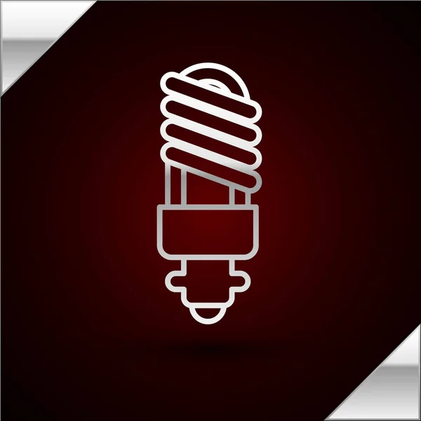 Silberne Linie LED-Glühbirne Symbol isoliert auf dunkelrotem Hintergrund. Sparsame LED-Leuchtmittel. Energiesparlampen sparen. Vektorillustration — Stockvektor