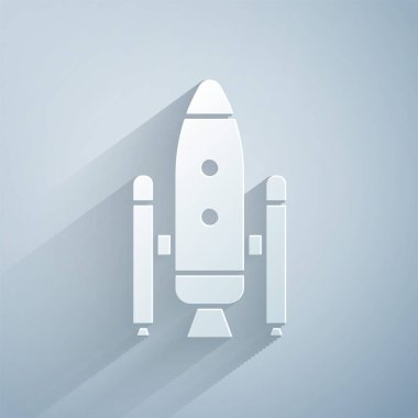 Kağıt kesiği uzay mekiği ve roket ikonu gri arka planda izole edildi. Kağıt sanatı tarzı. Vektör İllüstrasyonu