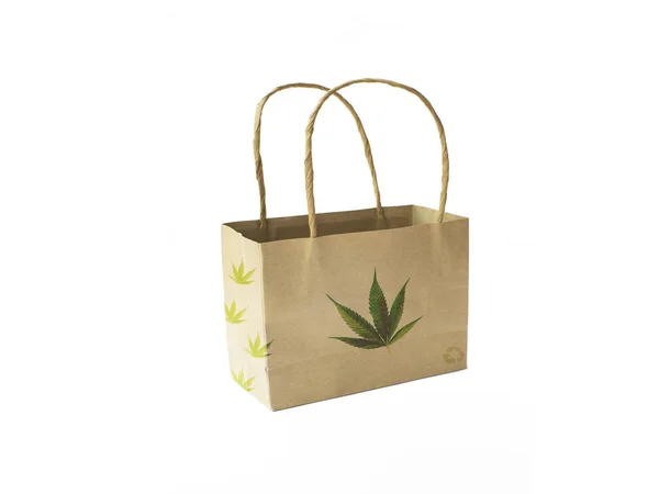 Recycled paper bag with a green marijuana plant logo on white background.