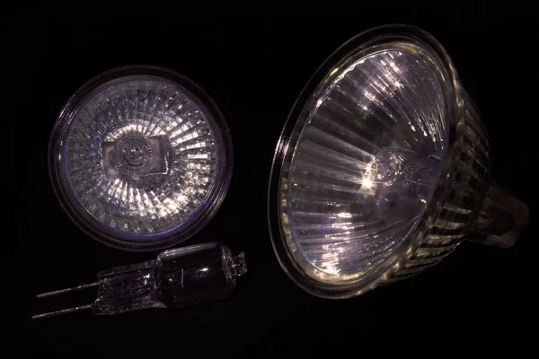 Mixed lot of halogen lamps close-up on black backgroun