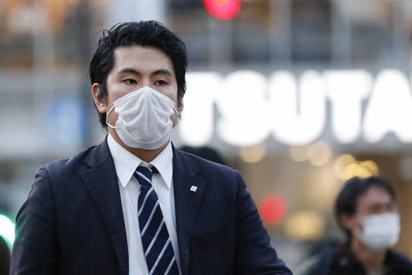 Tokyo, Japonya, 7 Nisan 2020 - Yayalar, Shibuya 'nın ünlü sınır kapısındaki yeni koronavirüs salgını sırasında önleyici bir önlem olarak yüz maskesi takıyorlar.. 