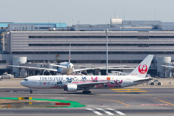 March 18, 2020, Tokyo, Japan - Japan Airlines (JAL) aircraft with logos of Tokyo Olympic Games 2020 (Tokyo 2020) is seen in Tokyo International Airport commonly known as Haneda Airport.