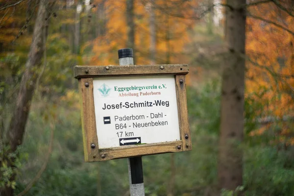 Josef-Schmitz-Weg hiking trail sign in German in forest