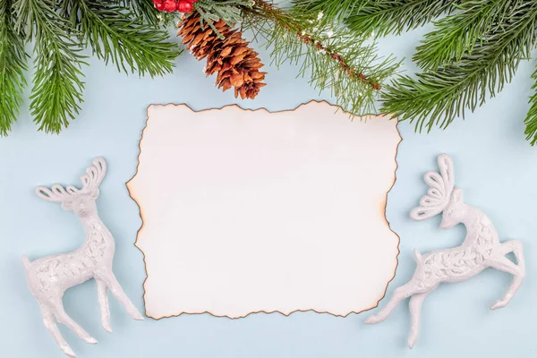 Blank greeting card in Christmas decorations - toy deers and pine tree branches — Stock Photo, Image