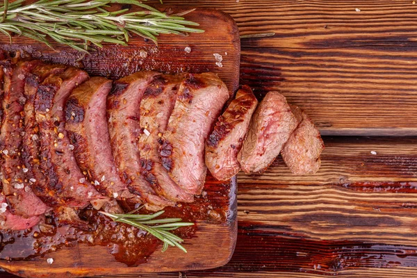 Sliced Grilled Meat Beef Steak Ribeye with Spices on Rustic Wooden Cutting Board — Stock Photo, Image