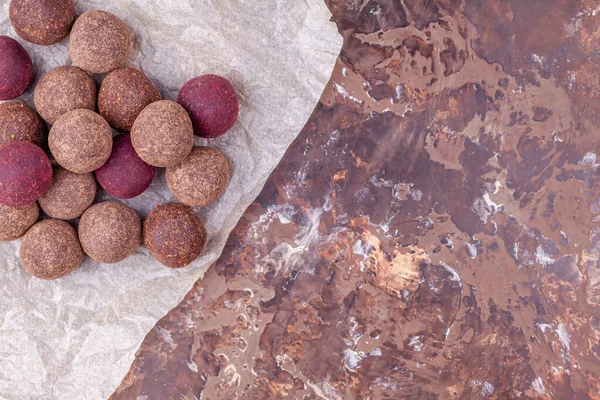 Homemade Raw Vegan Cacao Energy Balls on Craft Paper on Brown Background — ストック写真