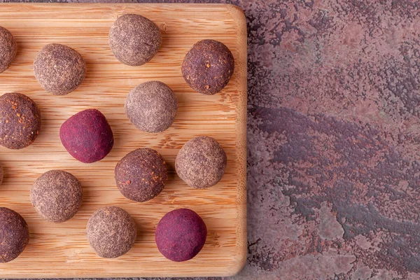 Close Up of Homemade Raw Cacao Energy Balls on Wooden Tray on Marble Background — ストック写真