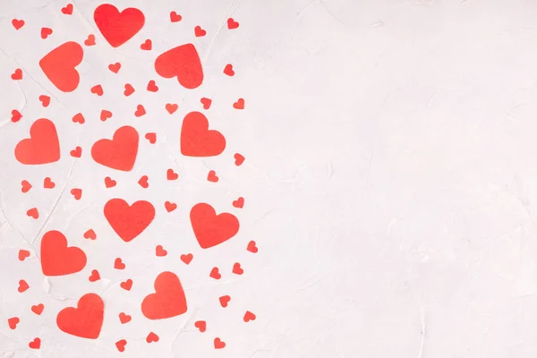 Valentines Background with Confetti Paper Hearts on Concrete Gray Background