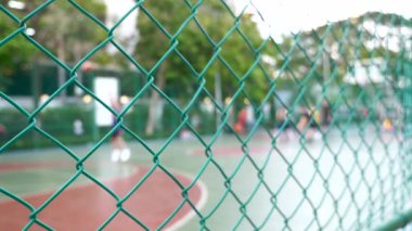 Blurred Defocused Background with Basketball Playground and Players on It
