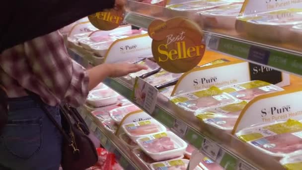 Two Woman Choosing Package with Pork Meat from the Shelf on Refrigerator — 비디오