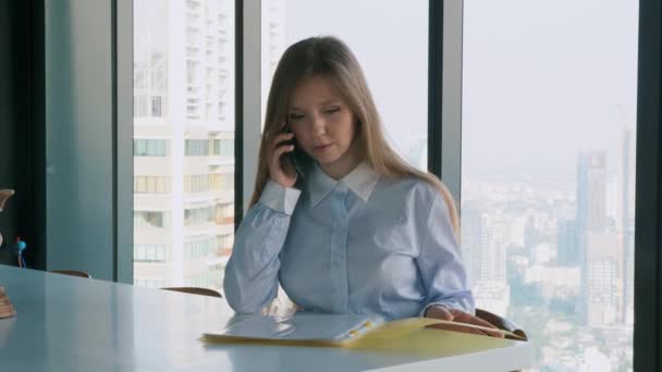 Concentrated Businesswoman Sitting in Office and Using Smartphone — 图库视频影像