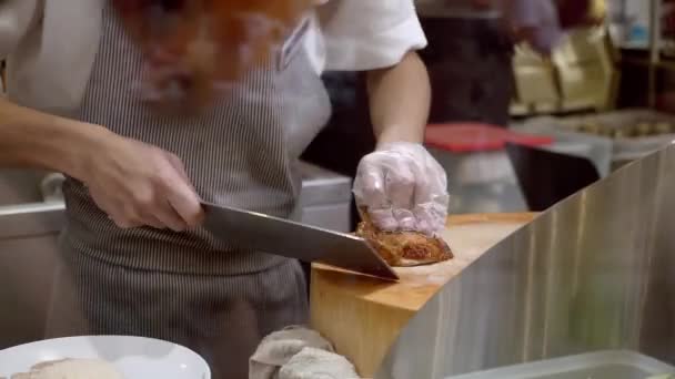 Chef Takes the Fried Chicken and Chops It with a Cleaver on Wooden Board — Stockvideo