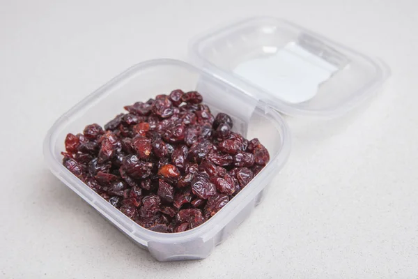 Transparent plastic bowl full of dried blueberry — Stock Photo, Image