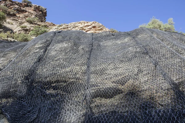 Mountain slope reinforced metal protective mesh, Spain — Stock Photo, Image