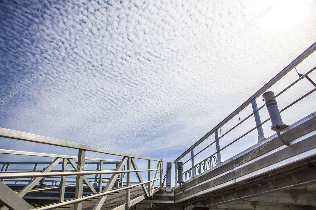 Marina footbridge over blue cloudy sky, Spain