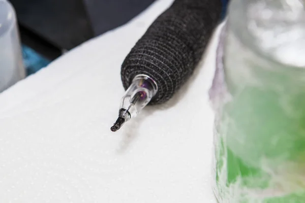 Pen ink machine over paper towel with head covered with black in — Stock Photo, Image