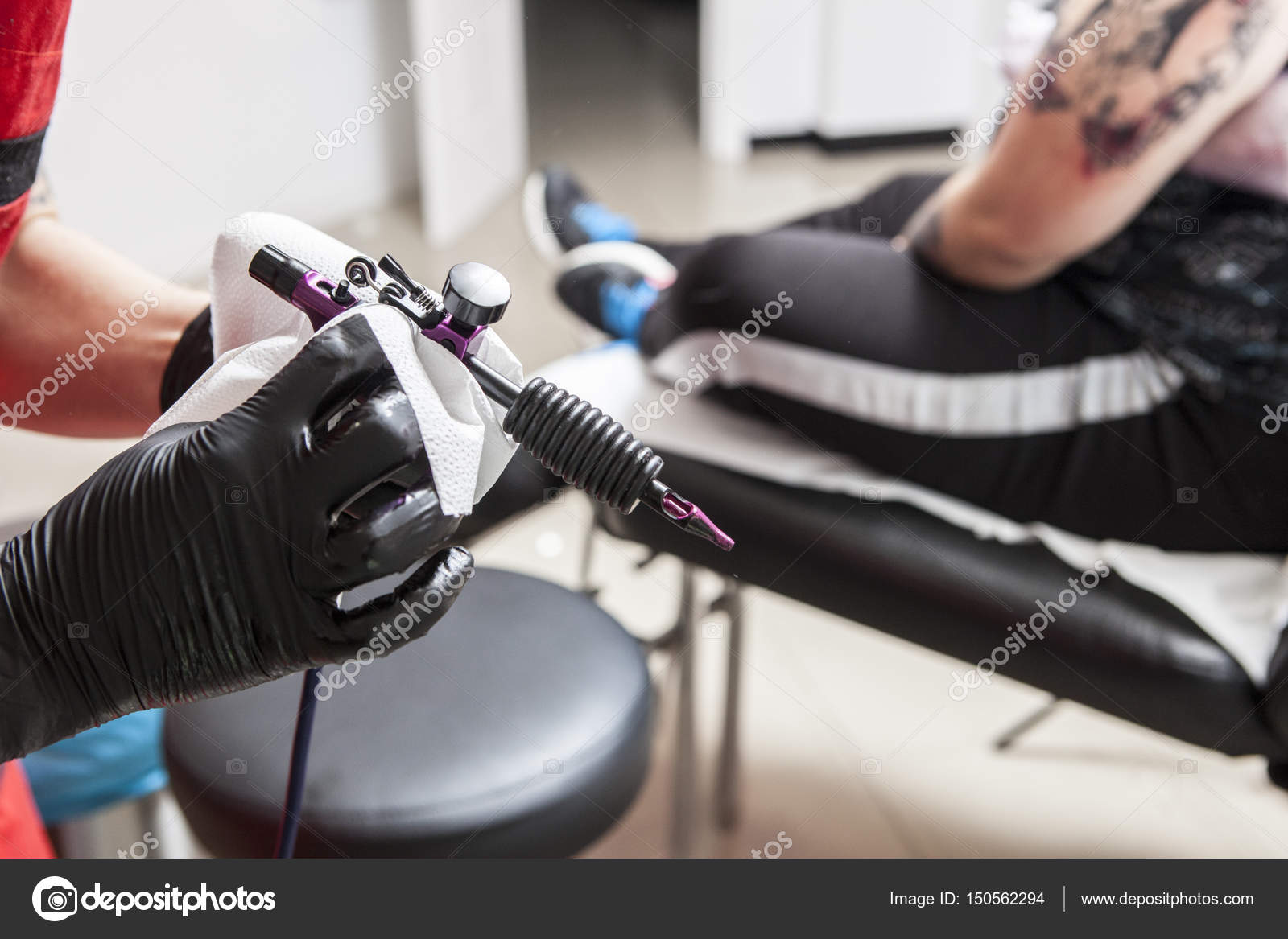 Tattoo artist clean with paper towel the gun ink machine Stock Photo by ©WHPics 150562294