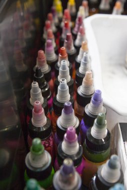 Bir dövme salonu kutusunda renkli dövme mürekkepleri şişe