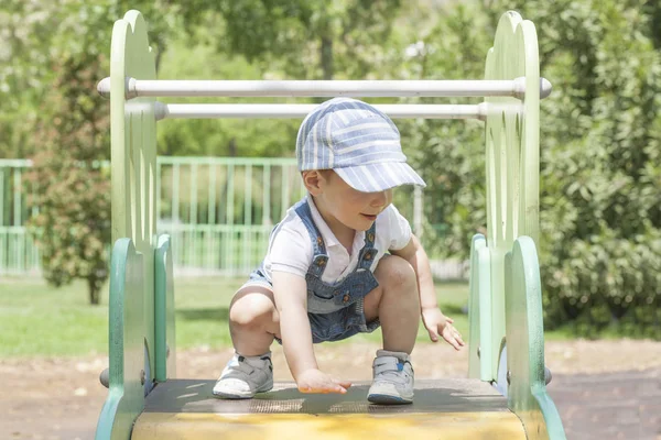 Baby boy on the top of the slider. Balance concept — Stock Photo, Image