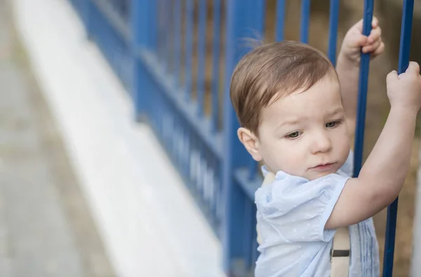 Niño trepando por la valla . — Foto de Stock