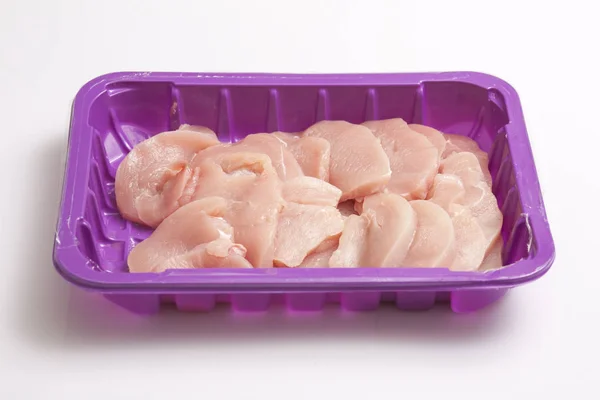 Fresh turkey leg fillets on a purple plastic meat tray — Stock Photo, Image