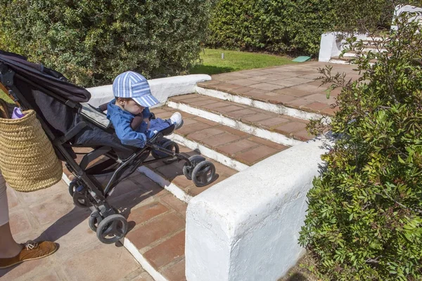 Mother carries a stroller down the stairs without ramp — Stock Photo, Image