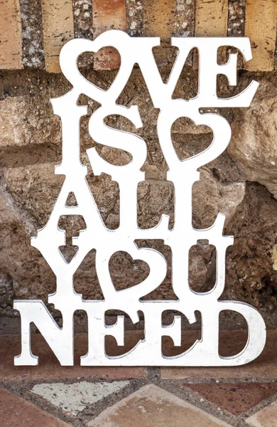 Love is all you need sing over rustic ground