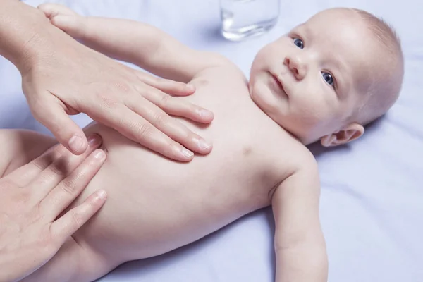 Three month baby boy abdomen massage — Stock Photo, Image