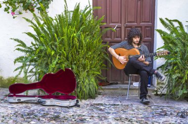 Spanish guitar player at traditional enclosed courtyard of Cordo clipart