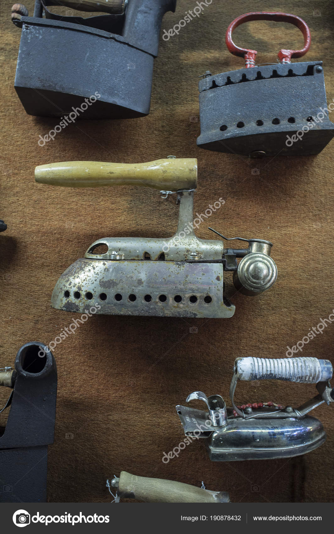 Collection of old metal clothes irons displayed on wall — Stock Photo