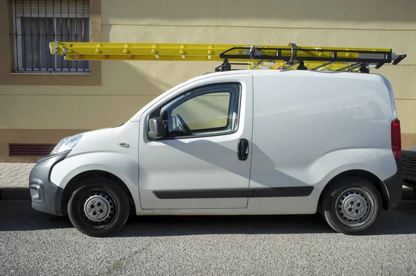 Delivery van loaded with yellow ladders — Stock Photo, Image