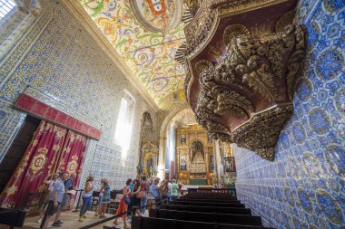 Coimbra, Portugal - Sept 6th 2019: Visitors at University Chapel or Capela de Sao Miguel Chapel. Tourist attraction of university old quarter, Coimbra, Portugal