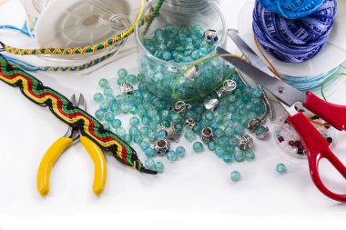 Kolyeler, bilezikler, gümüş takımlar, makas ve iplikler için boncuklar.