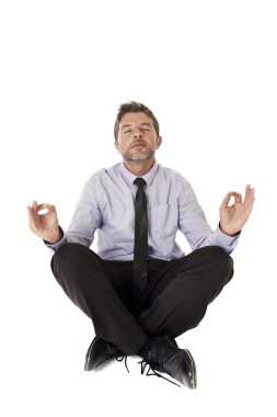 young attractive happy businessman relaxing with hands in yoga position sitting on the floor
