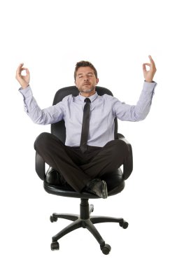 young attractive happy businessman relaxing with hands in yoga position sitting on office chair