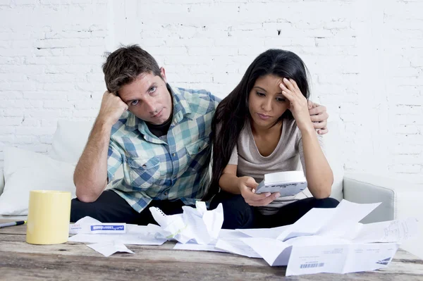 Young sad couple at home living room couch calculating monthly expenses worried in stress — Stockfoto