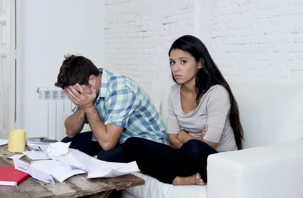 young sad couple at home living room couch calculating monthly expenses worried in stress