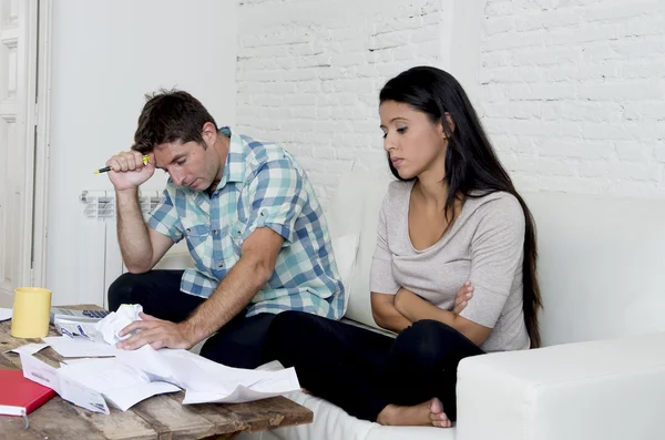 Young sad couple at home living room couch calculating monthly expenses worried in stress — Stock Photo, Image